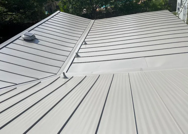 Solar attic fan installed on a metal roof for Roof Ventilation in Elk Grove Village